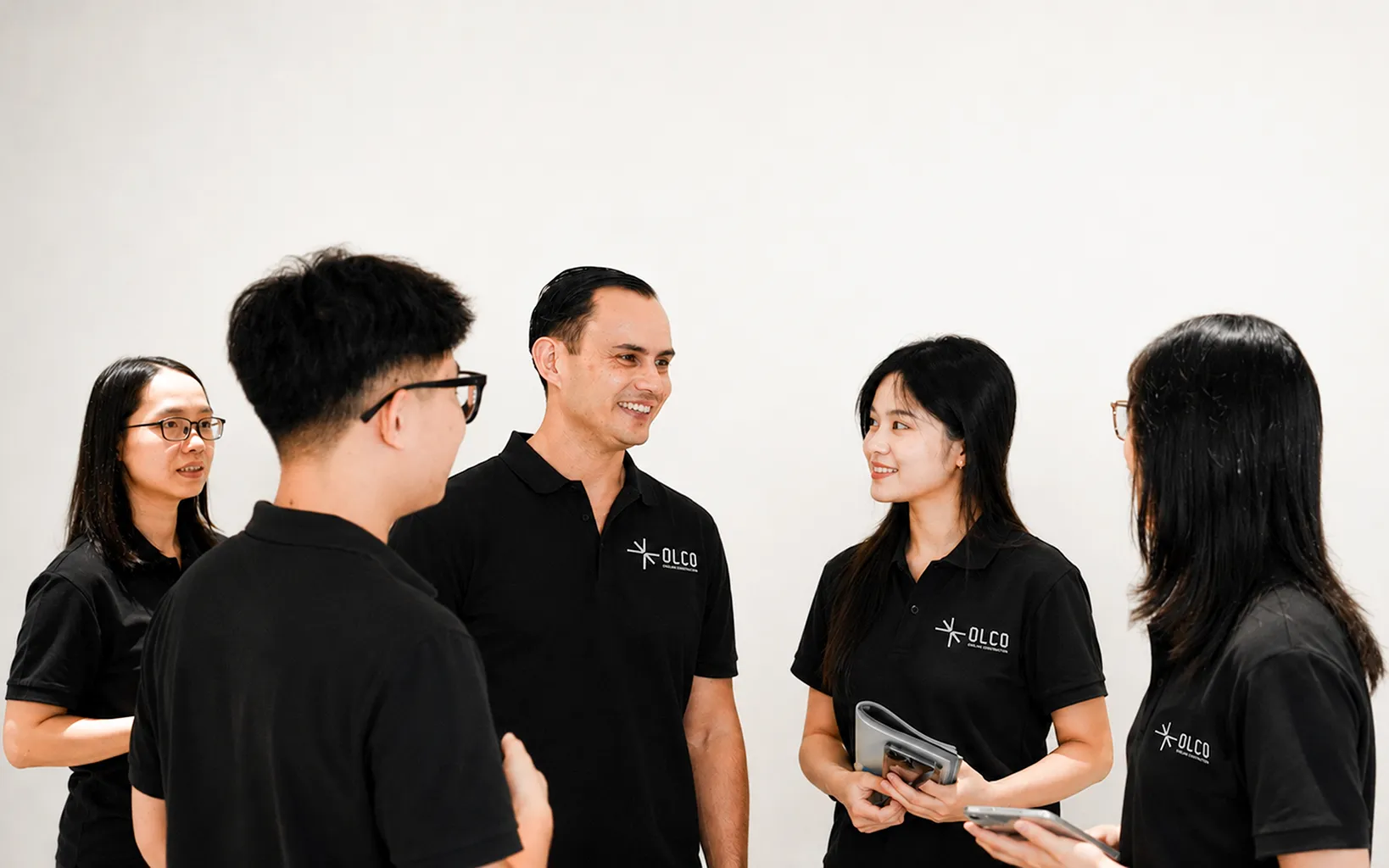 Three OLCO team members walking through a partner manufacturing facility