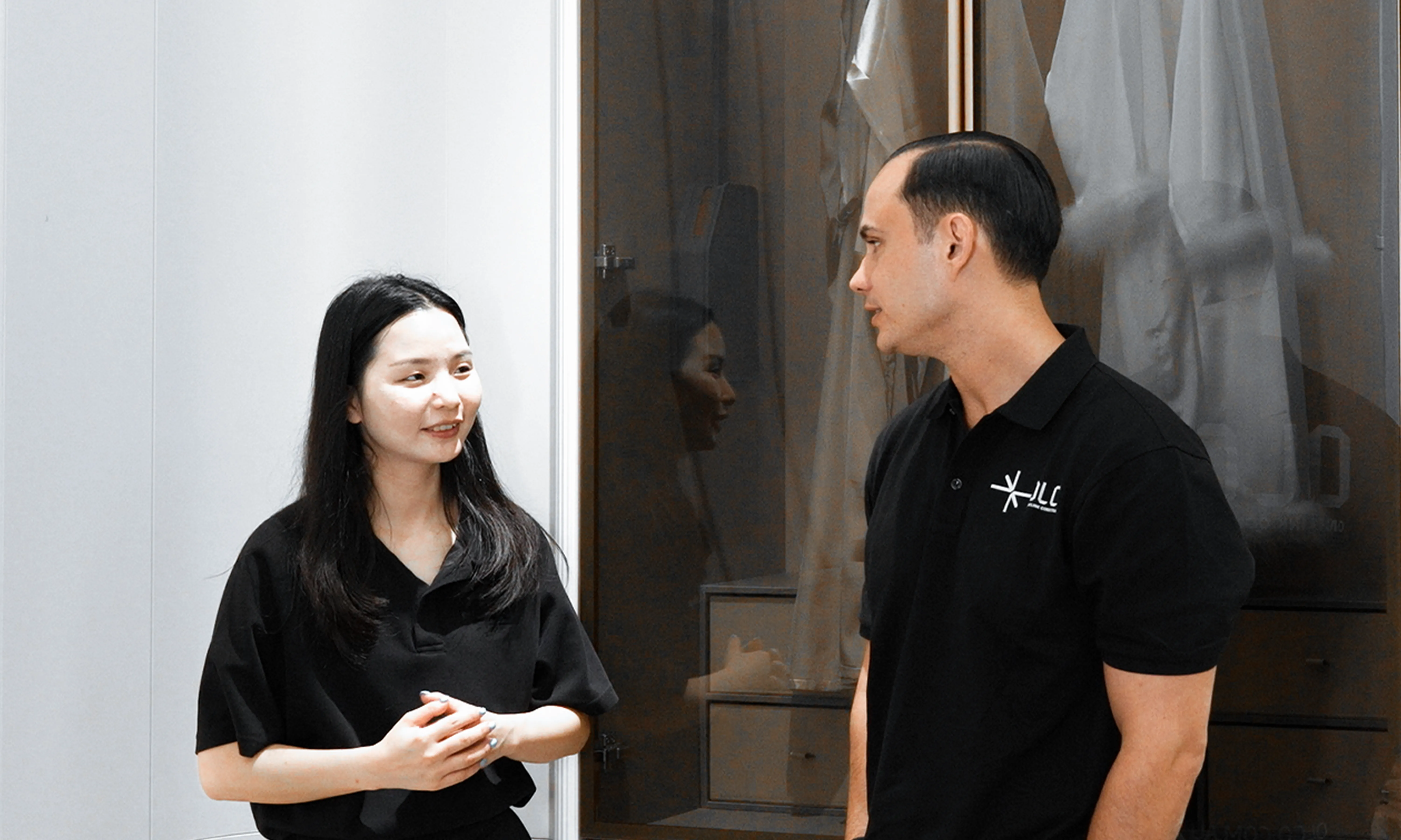 Two OLCO team members discussing a door sample with a supplier